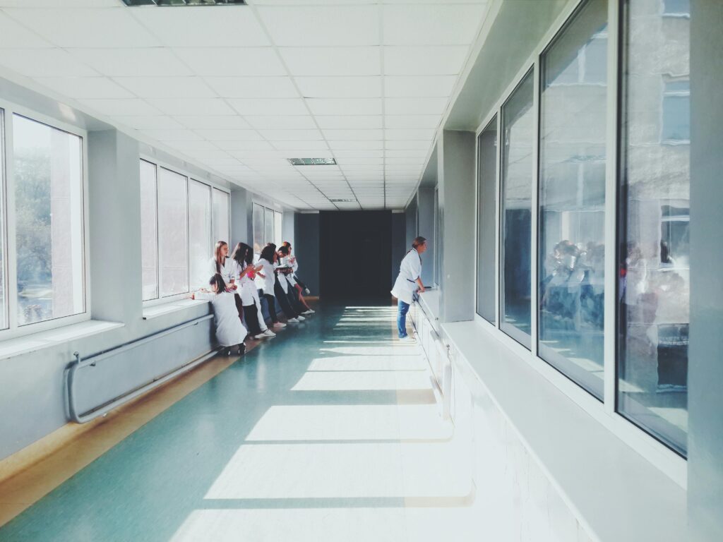 pexels-photo-127873-127873 A brightly lit hospital hallway with medical staff in white coats, conveying a professional healthcare environment.